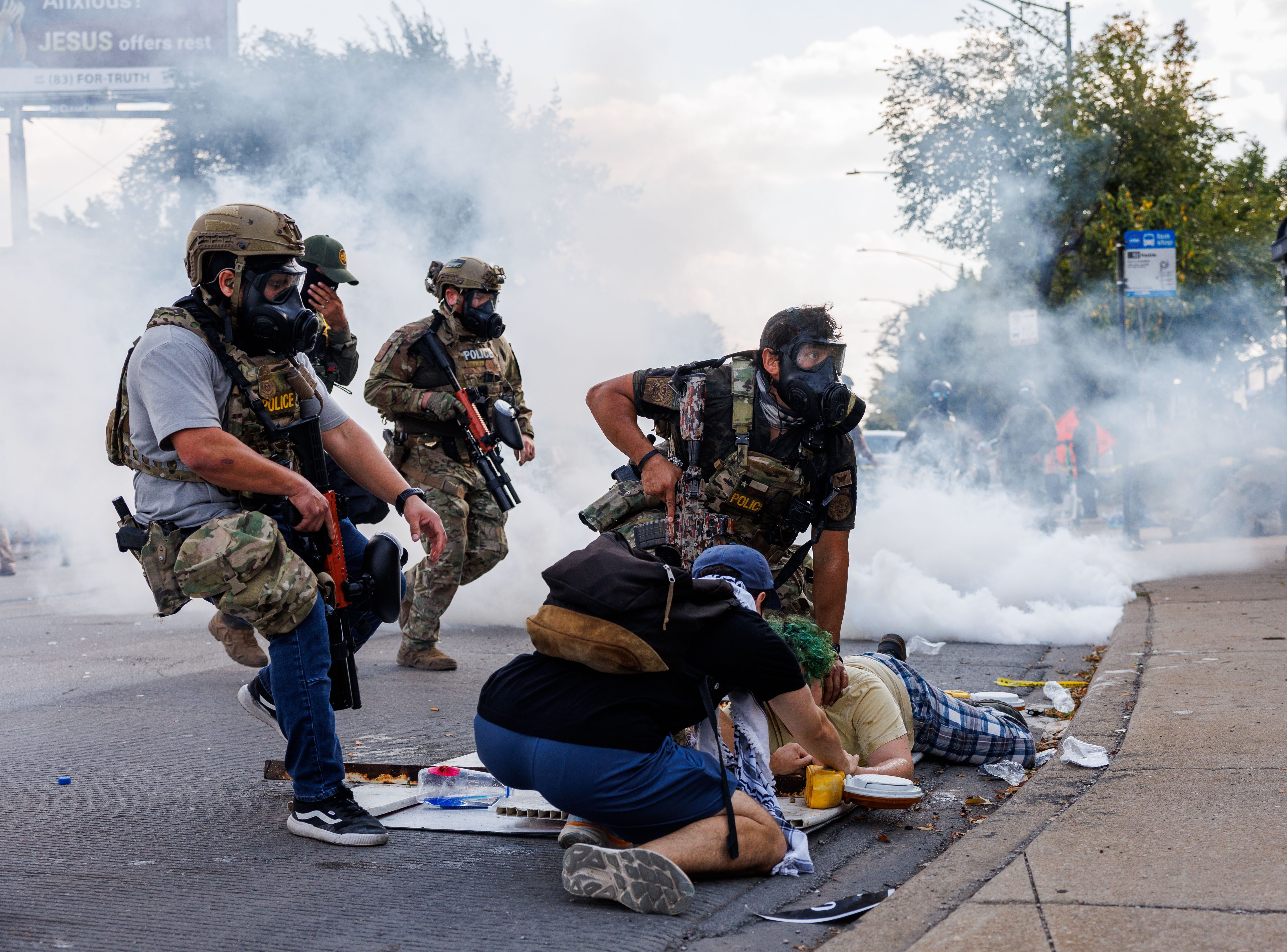 Federal officers detain a person while members of the community and activists protest near the 3900 block of South Kedzie Avenue, Oct. 4, in Chicago.